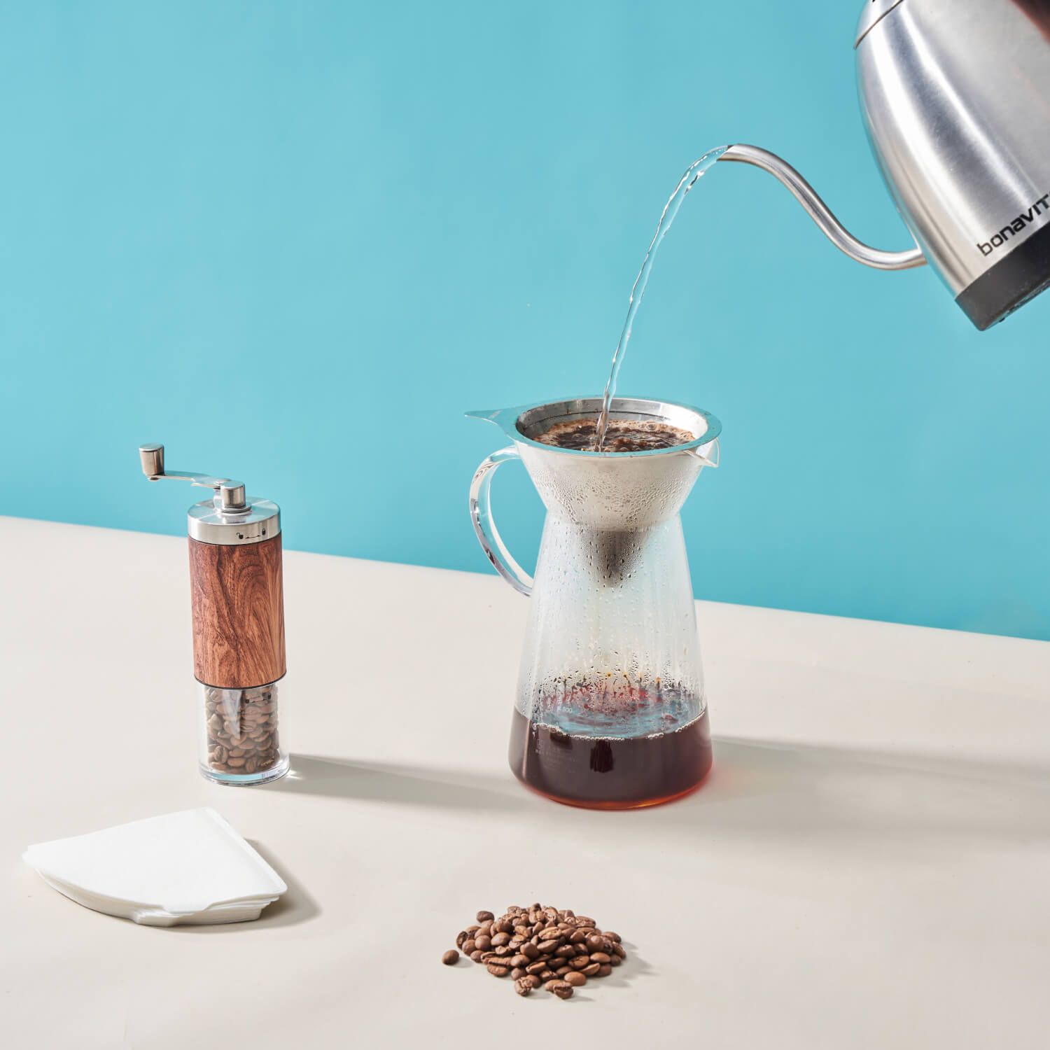 Pouring hot water over a dripper to brew coffee